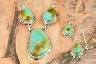 Genuine Manassa Turquoise set in Sterling Silver. Beautiful Necklace and Earrings Set. This Turquoise is also referred to as King�s Manassa Turquoise. The Manassa Turquoise mine is located in Manassa, Conejos County, Colorado. Created by Navajo Artist Kathy Yazzie. Signed by the artist.